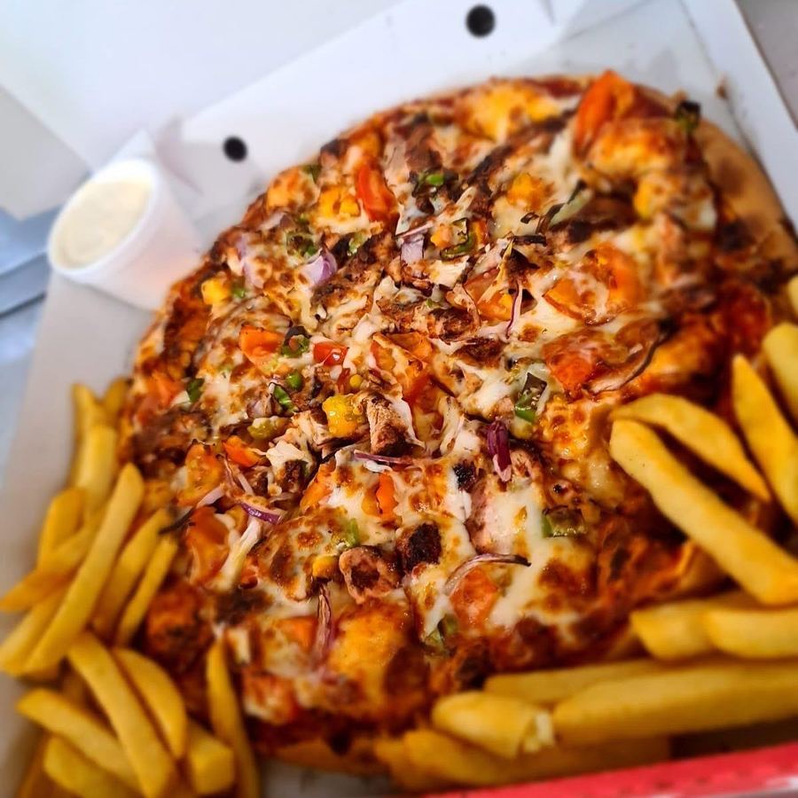 Express Pizzeria pizza served in a box with a side of chips